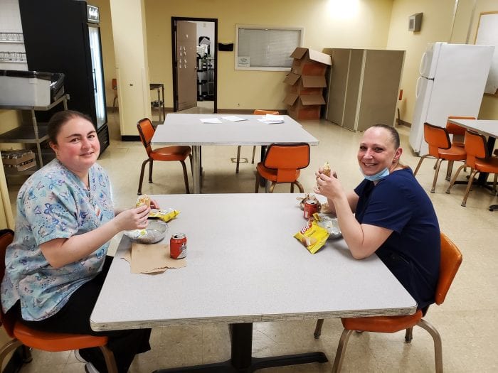 Staff at Nursing Home eating donated food