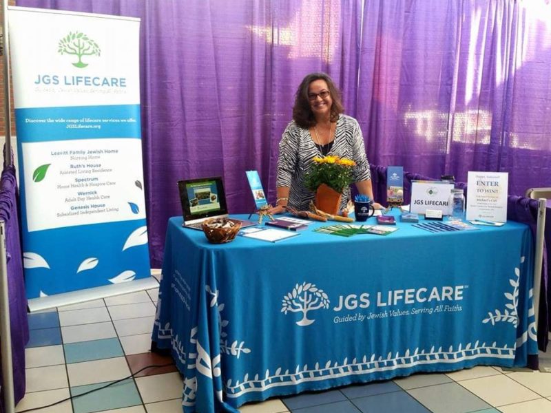 Mary-Anne behind a JGS Lifecare table
