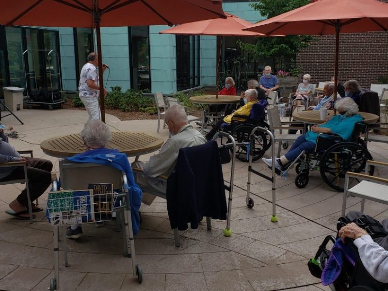JNH Residents listen to music outdoors.
