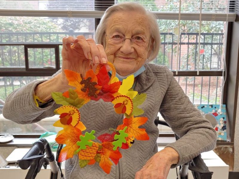 A resident with her fall leaf craft.