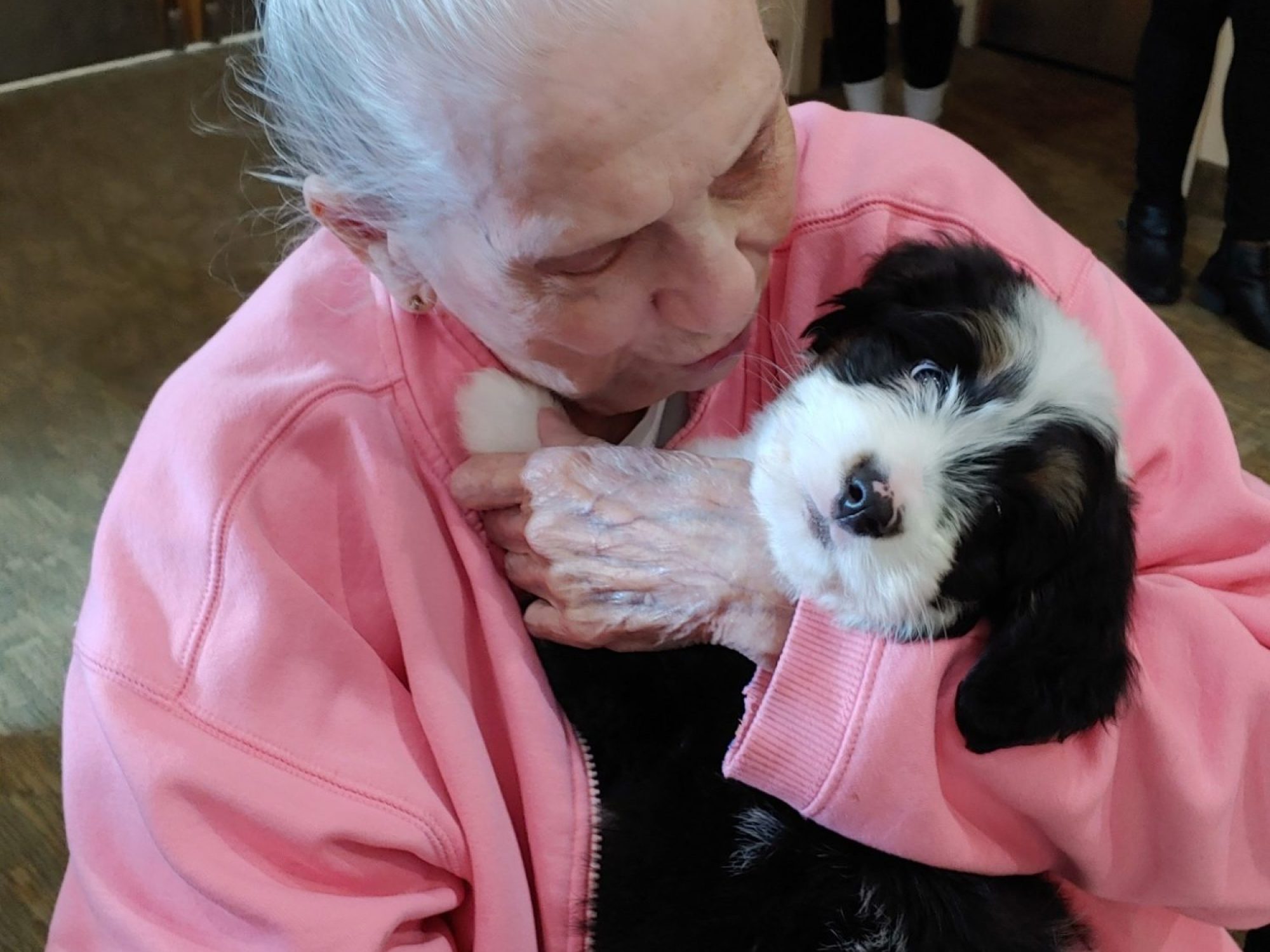 A resident posing with a puppy