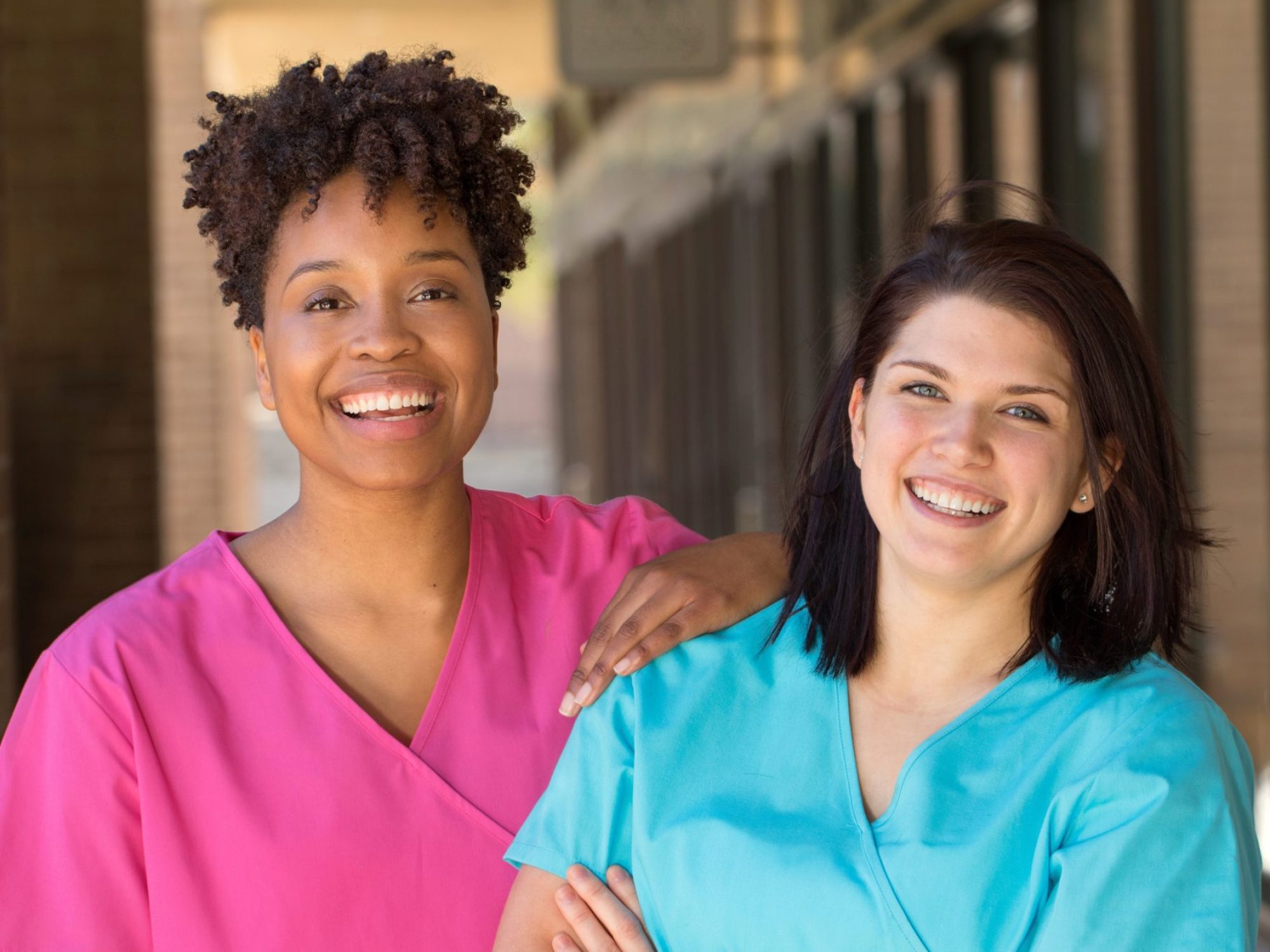 Two female nurses smiling for the camera