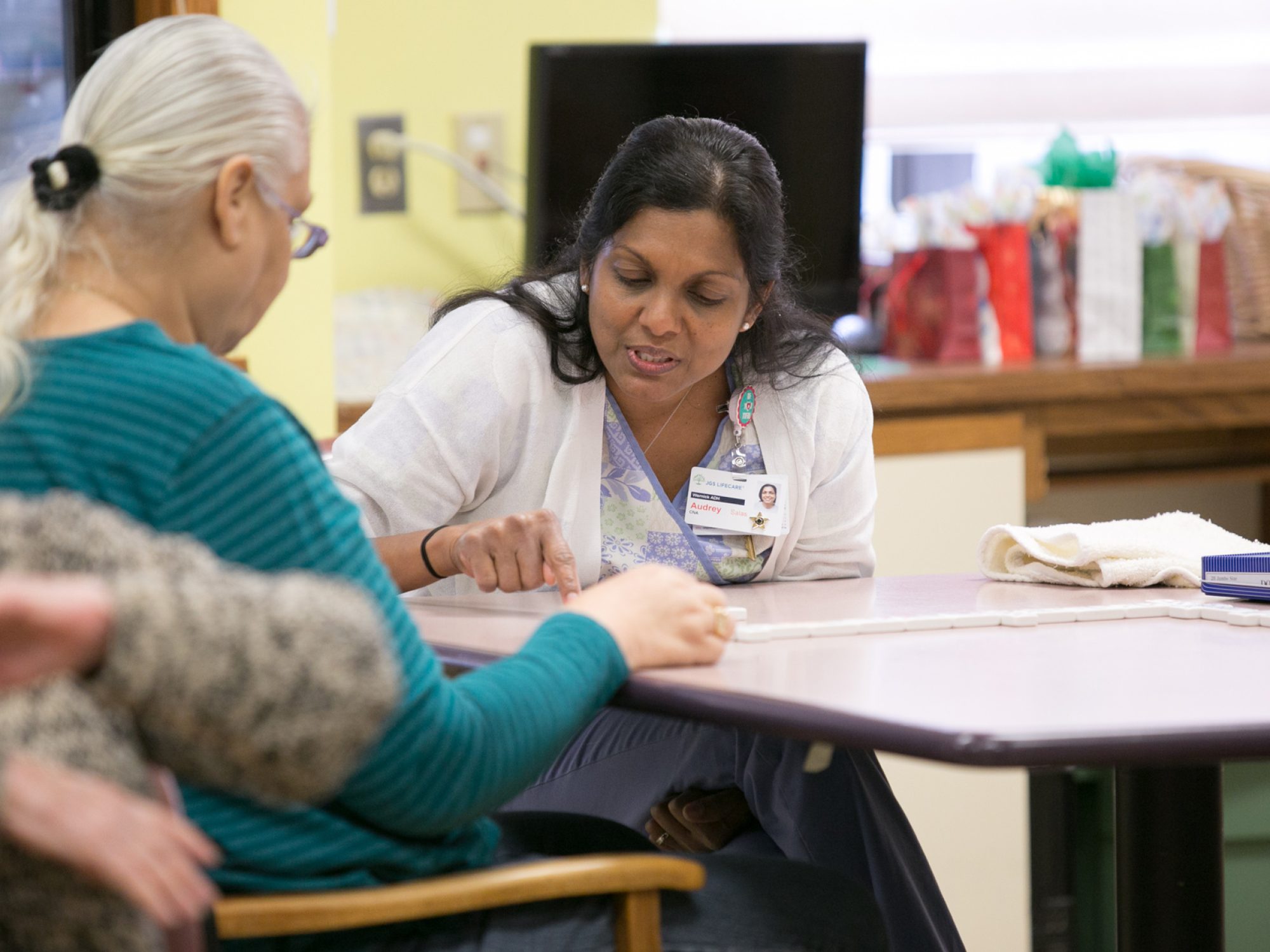 A JGS CNA working with a patient.