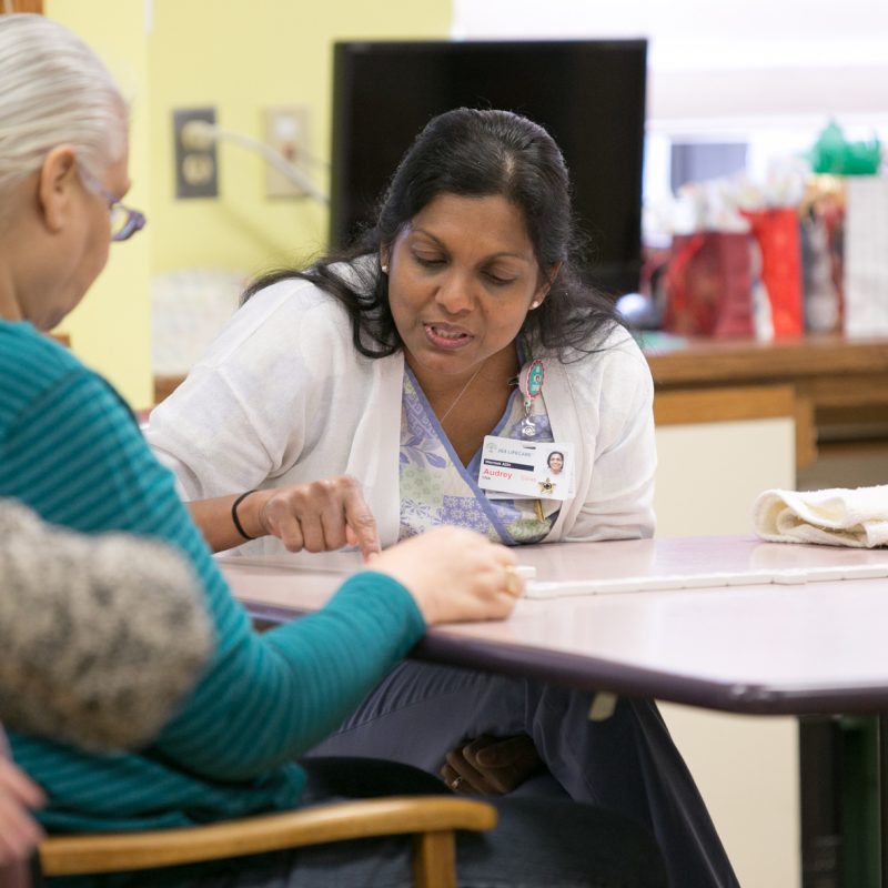 A JGS CNA working with a patient.