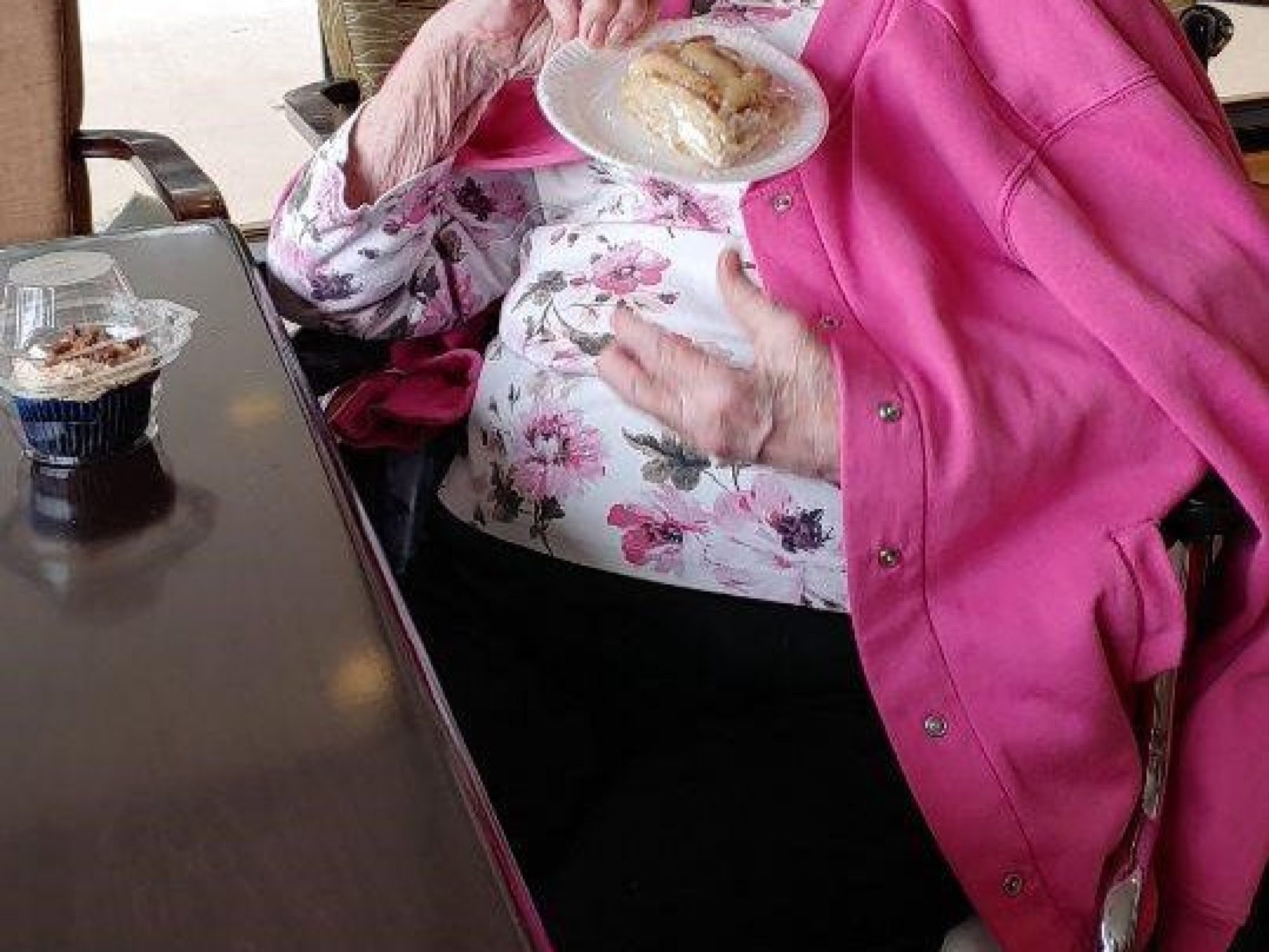 A resident enjoys a baked good from the bake sale fundraiser.