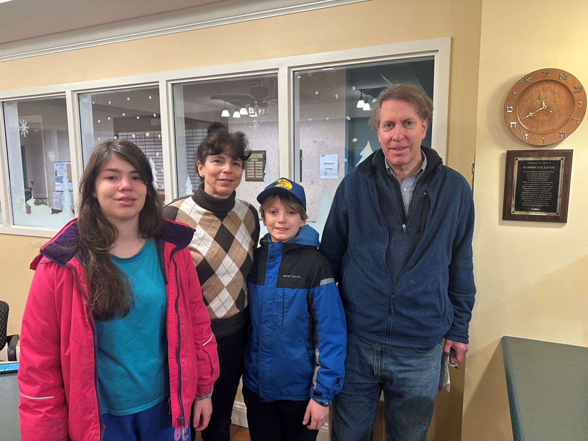 The Lavin family standing next to the plaque